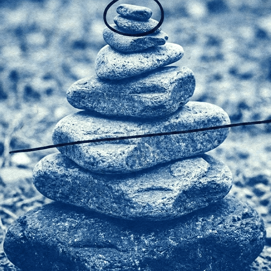 a stack of flat stones, the top one ringed in ink and a rule struck across the pile
